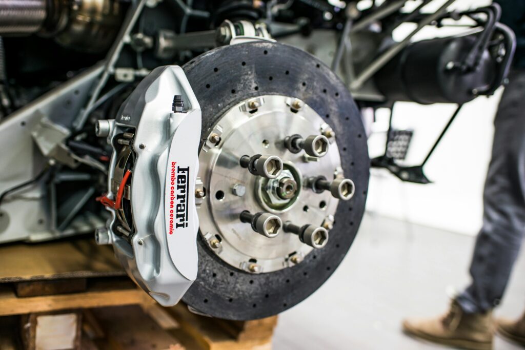 pexels-photo-3642618-3642618 Detailed view of disc brake and caliper on a high-performance car, emphasizing precision and technology.